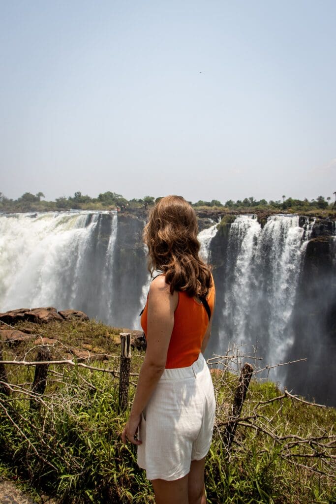 woman looking at Victoria Falls in Africa